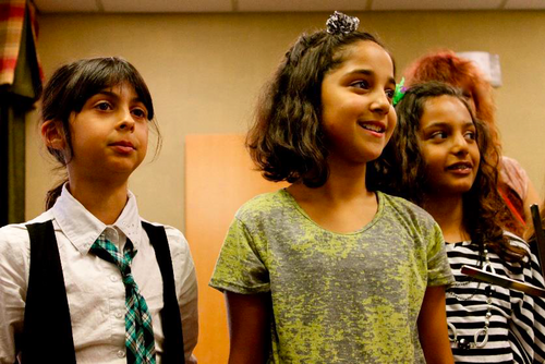 Three young women facing an audience.