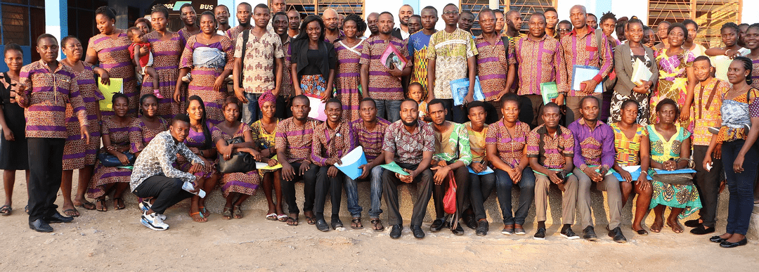 A large group of teachers arrange themselves for a.