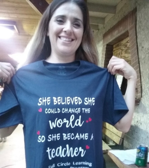 Woman with t-shirt that reads She believed she could change the world so she became a teacher