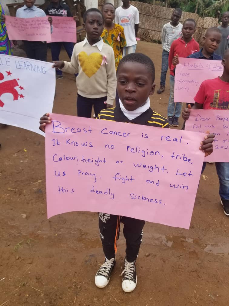 Cameroonian children spreading awareness of breast cancer.